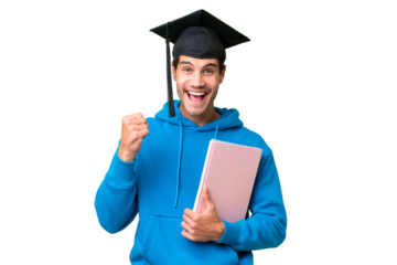 Young university graduate man over isolated background celebrating a victory in winner position