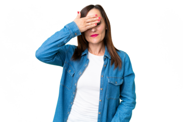 Middle age woman over isolated chroma key background covering eyes by hands. Do not want to see something
