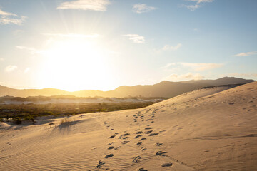 Sunset on the Joaquina dunes, white sand dunes on the island of Florianopolis, Santa Catarina, Brazil.
