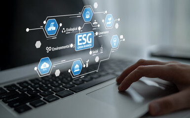 Obraz premium Close-up view of a hand using a laptop, showcasing multiple ESG icons on the screen, representing key factors in responsible business practices and sustainability trends. Tessel