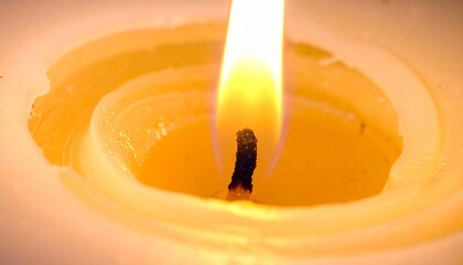 Warm, flickering candle flame illuminates melted wax, creating a serene and peaceful atmosphere with soft, glowing light.