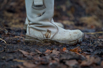 Close-up of men's rugged work boots on a job site, with reinforced toes and heavy-duty soles....