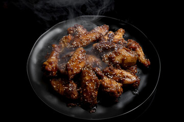 Smoked chicken wings glazed in sticky soy sauce 