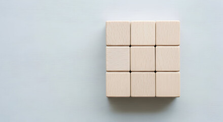 Obraz premium Elevate your project with this clean, minimal shot of nine wooden blocks, perfect for adding a touch of natural simplicity and organic feel to your design work.
