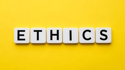 Word ethics spelled out with white letter tiles on a bright yellow background, concept of morality and principles