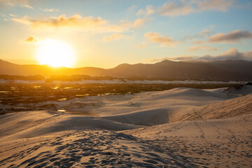 Sunset on the Joaquina dunes, white sand dunes on the island of Florianopolis, Santa Catarina, Brazil.