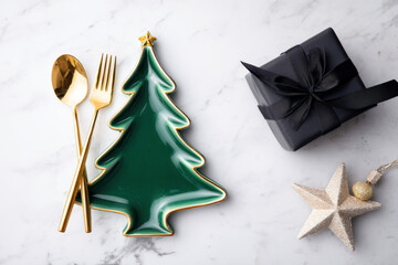 A festive holiday table setting featuring a ceramic Christmas tree plate with ribbon and pine sprig, surrounded by gifts