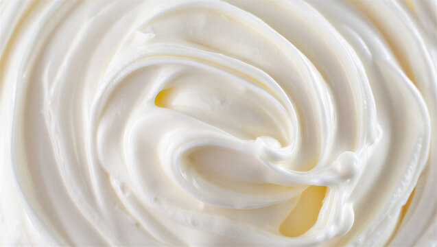 Close up of swirled white cream with golden highlights