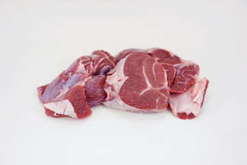 three pieces of raw beef shank isolated on white background