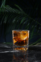 Old Fashioned cocktail in a glass on a dark background