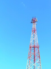 Cellular Communication Tower Infrastructure Against Bright Blue Sky Providing Modern Global Telecommunication Network and Wireless Digital Connectivity Technology for Mobile Data and Broadcast Signal 