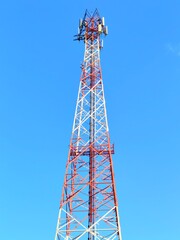 Cellular Communication Tower Infrastructure Against Bright Blue Sky Providing Modern Global Telecommunication Network and Wireless Digital Connectivity Technology for Mobile Data and Broadcast Signal 