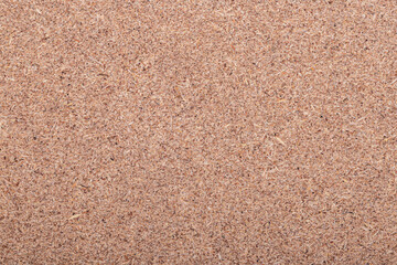 Close-up wood fiber board texture with fine brown surface pattern, suitable for background or design material.