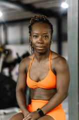 Black woman athlete confidently posing in gym