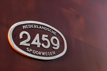Close-up of a vintage oval number plate 2459 from the Dutch Railways (Nederlandsche Spoorwegen)...