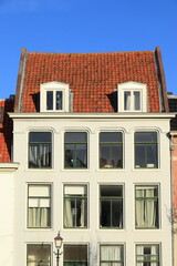 Haarlem Nieuwe Gracht White House Facade with Red Roof Tiles and Blue Sky, Netherlands