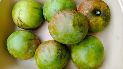 Fresh Whole Green Mangoes in a Tray