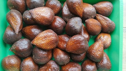 Pile of Fresh Snake Fruit (Salak) in Green Tray