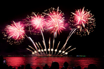 Amazing beautiful colorful firework display over sea on celebration night. Fireworks show for happy new year	