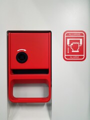 Red fire alarm box on a white background. Red fire alarm box.