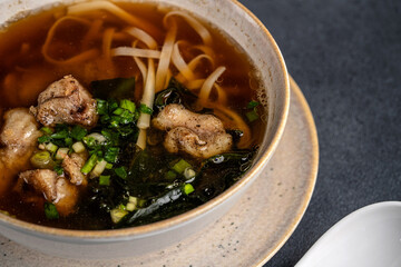 Asian noodle soup with pork close up
