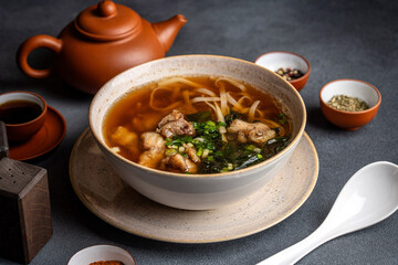 Asian pork noodle soup with tea set