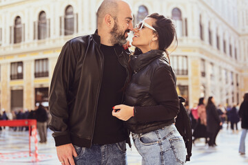 Happy smiling beautiful  Tourists  couple traveling at  Naples Italy, poses and making photos at Galleria Umberto,.Italy.Concept of Italian gastronomy and travel. Italian couple 