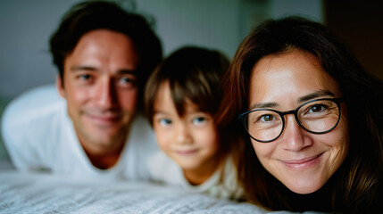 Obraz premium Family Portrait of Love and Togetherness: A loving family, comprised of a father, mother, and child, shares a tender moment. This close-knit unit embodies the warmth of familial bonds.