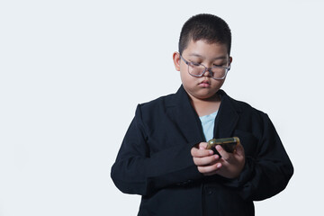 Asian boy using mobile phone isolated on white background with copy space.