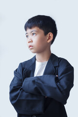 A young boy in a black suit, with a determined and ambitious expression, sets his sights on becoming a future businessman.