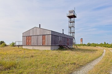 Former Soviet border guard post or watchtower and building with Loode lighthouse in the background...