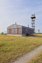 Former Soviet border guard post or watchtower and building with Loode lighthouse in the background...