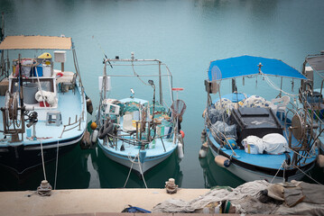 Fishing boats moored in a bustling harbor