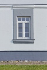Building&acute;s facade featuring a white double-sash, inward-opening flush casement window in sunny summer weather, S&otilde;rve Peninsula, Saaremaa, Estonia.