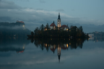Assumption of mary pilgrimage church on bled island reflecting . Slovenia, Europe