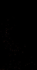 Realistic fire sparks flying through the air, isolated on a black background. Perfect as a cinematic VFX overlay, fire particles effect or visual element.
