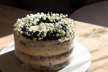 Beautiful handmade cake with floral topping for celebration