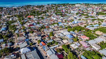 aerial landscape view of most northern part of  Nungwi village - a popular tourist destination, with Nungwi Rd, houses and buildings, located in the far northern end of island of Zanzibar 