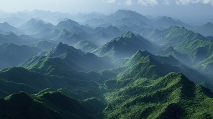 Lush Green Mountains Blanketed in Mist Captured from Above under Soft Morning Light
