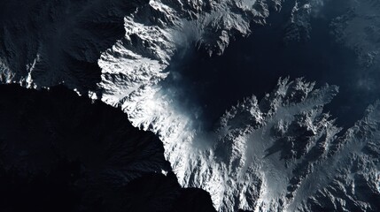 Aerial View of Snow-Capped Mountain Peaks Against Dark Background Captured from Space