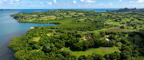 aerial view of Martinique landscape around Bay of Robert, a large bay on the Atlantic east coast of Martinique with many small islets, surrounded by green, hilly landscape