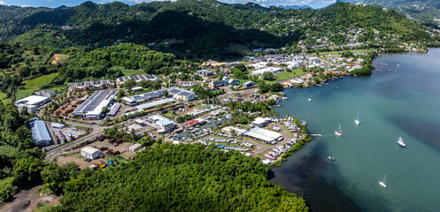 right panning across landscape around Bay of Robert, a large bay on the Atlantic east coast of Martinique with many small islets, surrounded by green hilly landscape, - 4k video footage 
