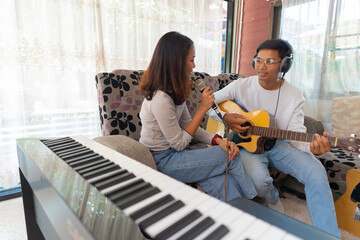 The couple is practicing playing a musical instrument.