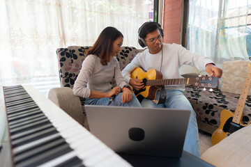 The couple is practicing playing a musical instrument.
