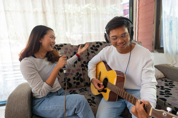 The couple is practicing playing a musical instrument.
