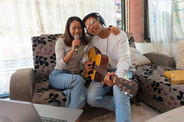 The couple is practicing playing a musical instrument.
