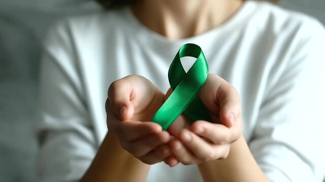 Green ribbon mental health awareness concept faceless glaucoma awareness isolated on white background psychological wellness symbol healthcare advocacy support representation