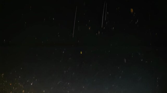 A mesmerizing display of golden lights against a dark night sky creates a celestial wonder. the glowing specks offer a mystical atmosphere, reminiscent of a starlit night or a festive celebration, ide