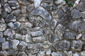 Irregular natural stone wall texture.