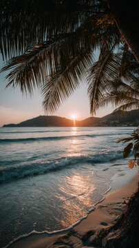 Sunset sea view with palm tree. Sunlight pierces clouds over ocean waves. Coastline shows calm turquoise water on empty tropical beach. Vacation parad
